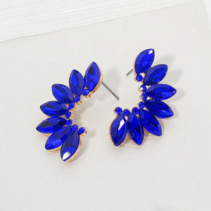 Sapphire Royal Blue crystal marquise wing-inspired earrings on gold with layered marquise stones, displayed on a white background.