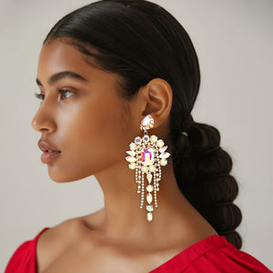 Long 4.6" AB on gold chandelier fringe earrings on a pretty lady on a white background — dramatic crystal statement jewelry for pageant, prom, weddings, and evening events.