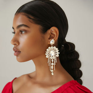 Long 4.6" clear crystal chandelier fringe earrings on gold on a pretty lady on a white background — dramatic crystal statement jewelry for pageant, prom, weddings, and evening events.