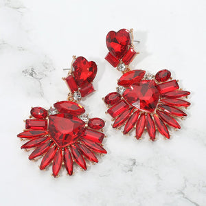 Red Heart Crystal Fan pageant and prom earrings on gold displayed on a white marble background