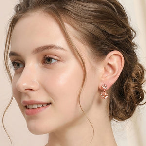 Small peach double round little girls pageant drop earrings on rose gold shown here on a model