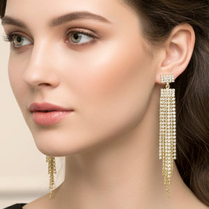 Long clear rhinestone tassel fringe earrings on gold worn by model