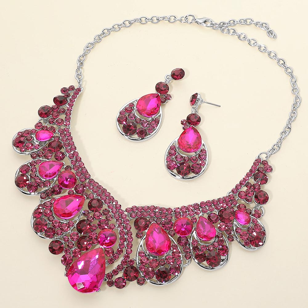 Fuchsia Hot Pink crystal teardrop necklace set on silver displayed on beige background