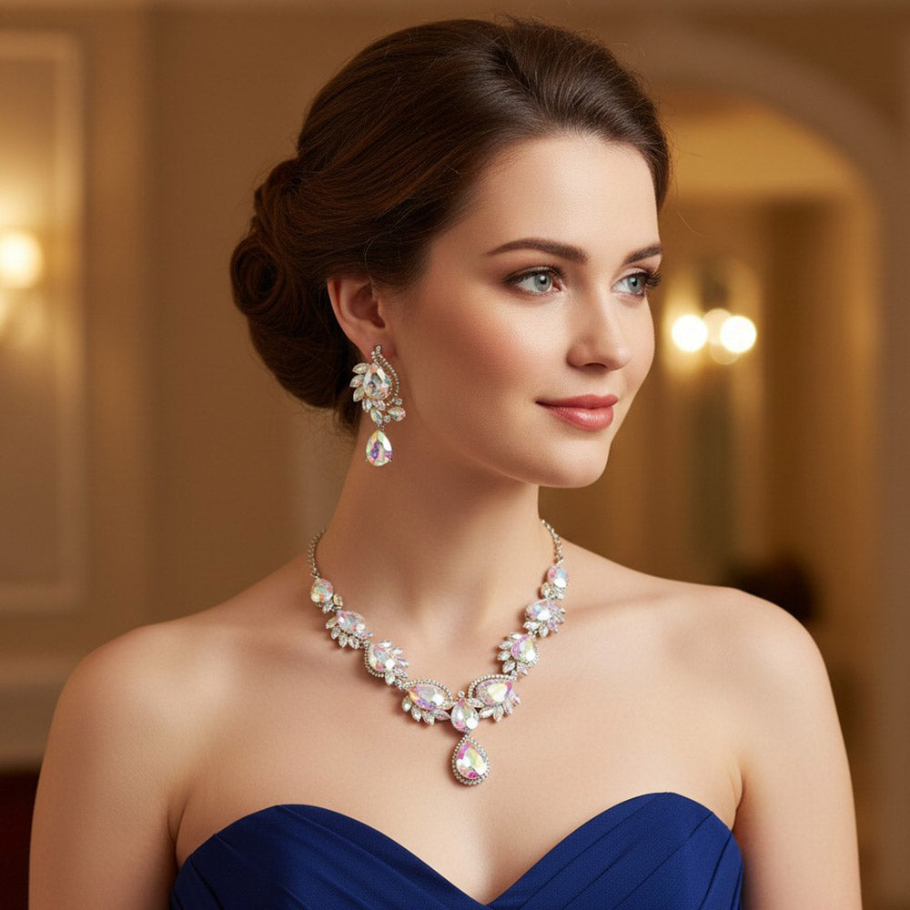 AB teardrop formal necklace and matching earrings set on silver displayed here on a model in a navy blue dress.  