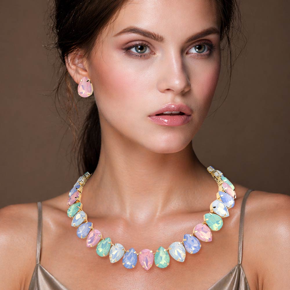 Multi-color pastel teardrop crystal prom necklace set on gold displayed on a model