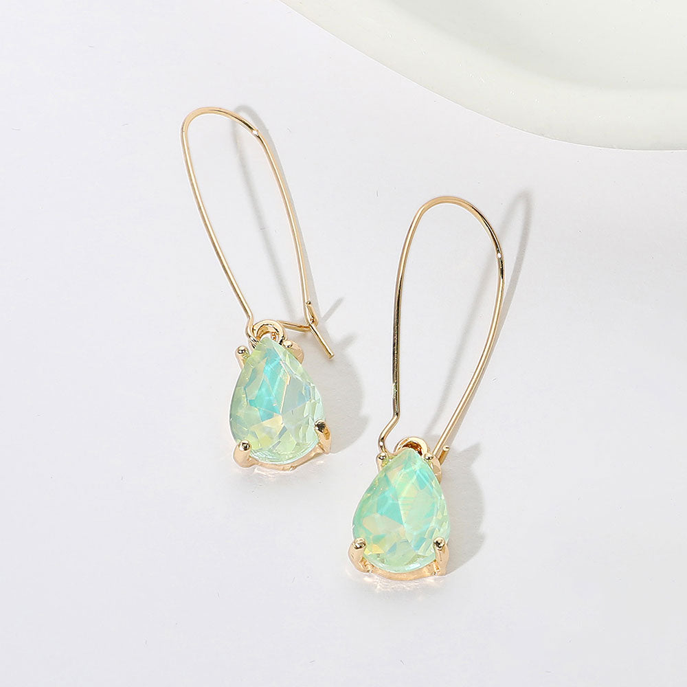 Elegant mint opal teardrop dangle pageant earrings on gold on white background