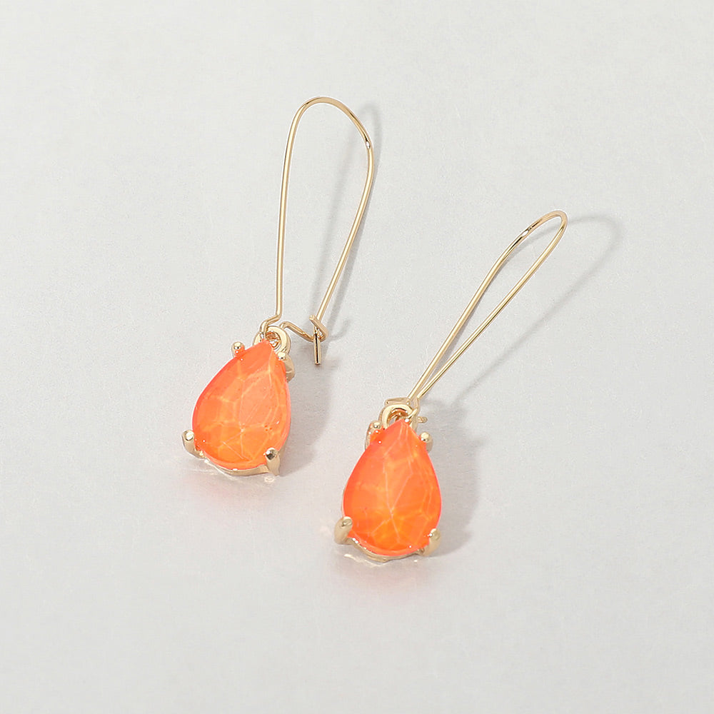 Elegant Neon Orange teardrop dangle pageant earrings on gold on white background