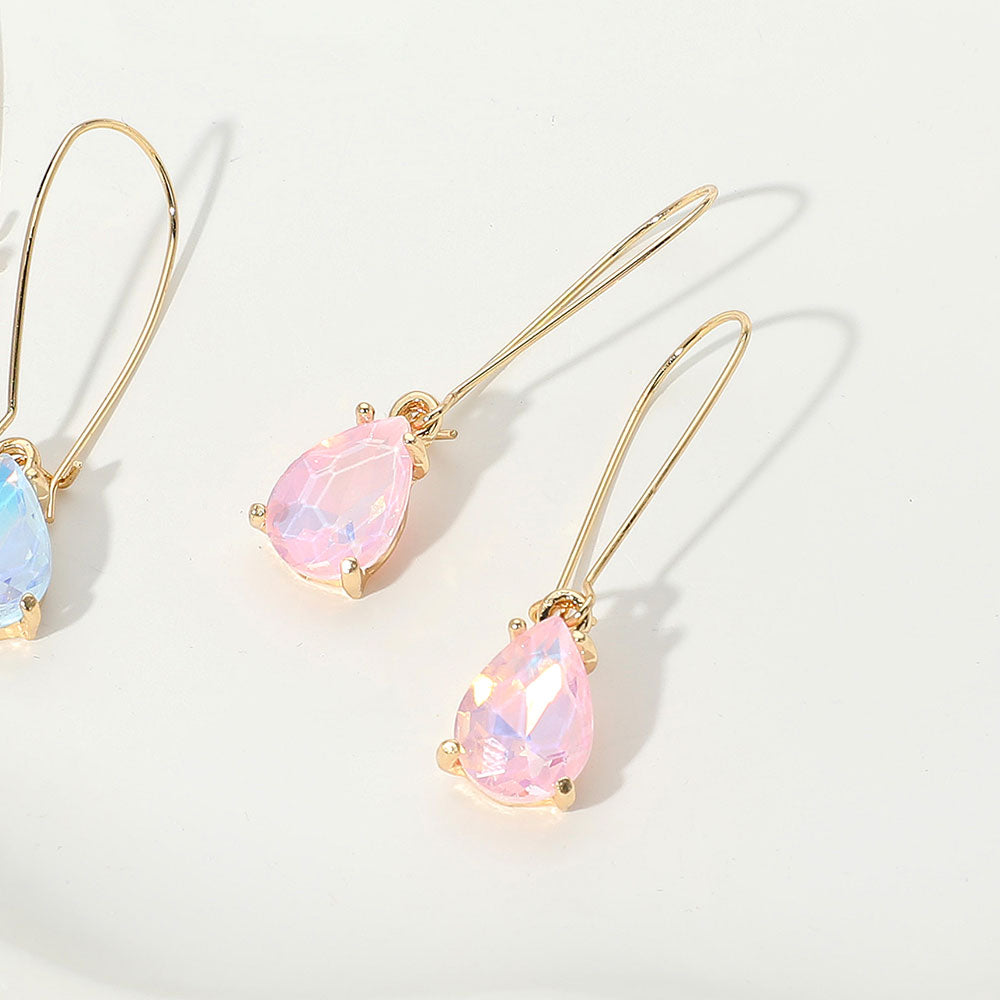 Elegant pink opal teardrop dangle pageant earrings on gold on white background