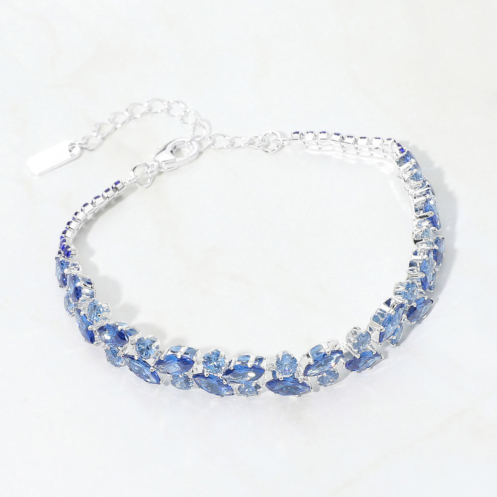 Light Blue multi-shape crystal bracelet on silver with marquise and round crystal accents and an extender chain, displayed on a white background.