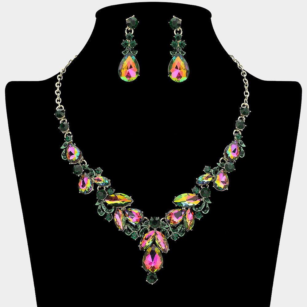 Emerald AB marquise stone necklace with gold teardrop rhinestone earrings on a black mannequin bust for prom or formal event