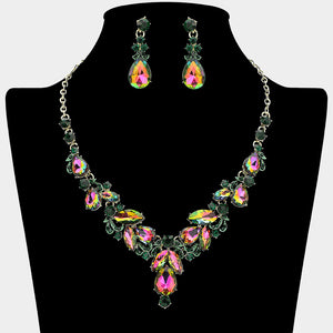 Emerald AB marquise stone necklace with gold teardrop rhinestone earrings on a black mannequin bust for prom or formal event