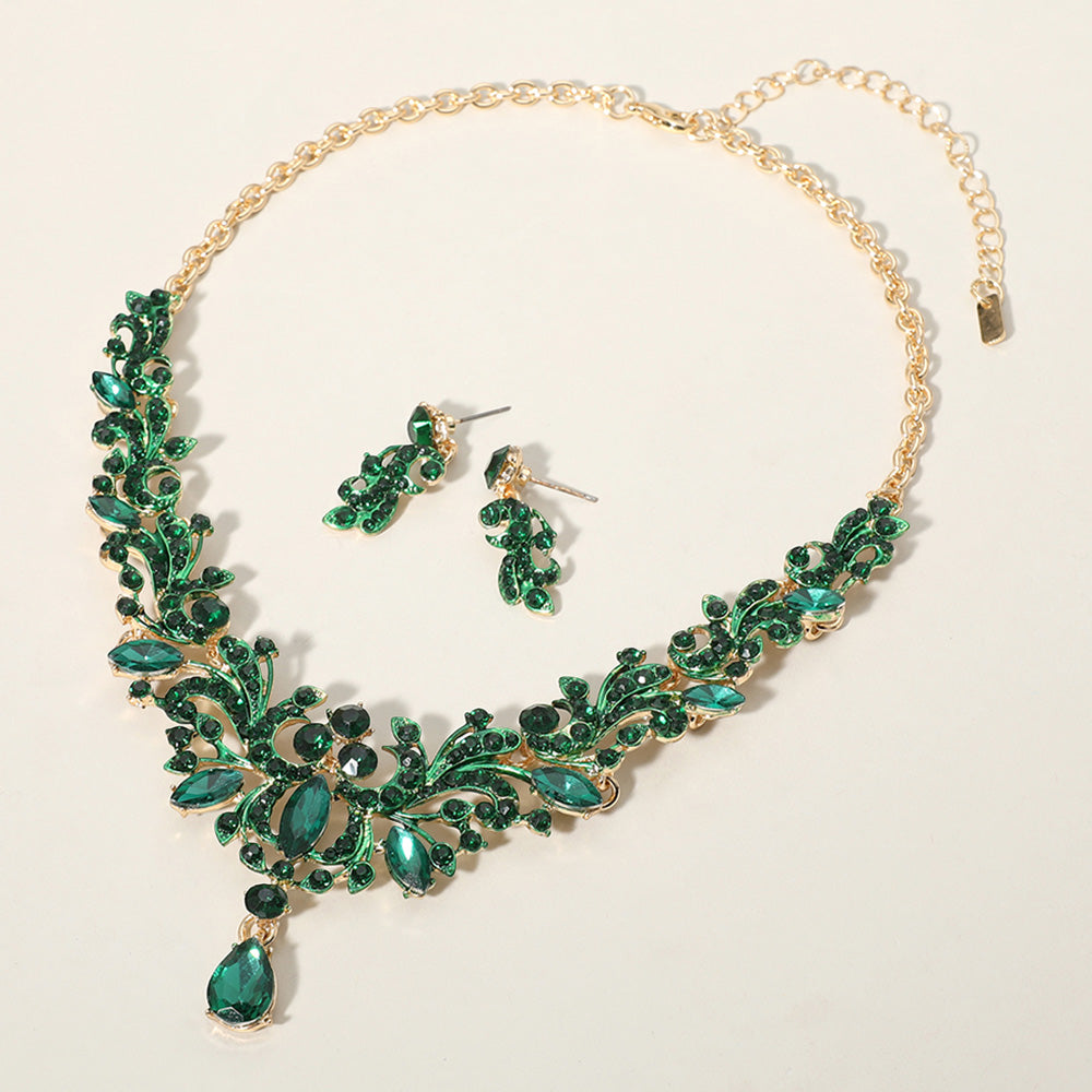 Emerald emerald green stone cluster prom necklace set on gold with matching earrings on a cream background