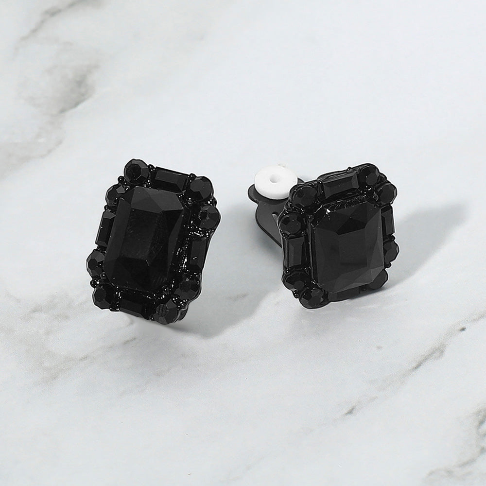 Emerald Cut Jet Black Stone Clip On Earrings black backed on a grey and white granite background