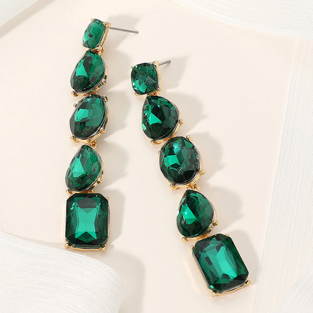Emerald green faceted stone cluster prom pageant evening earrings in a gold setting on an off white background