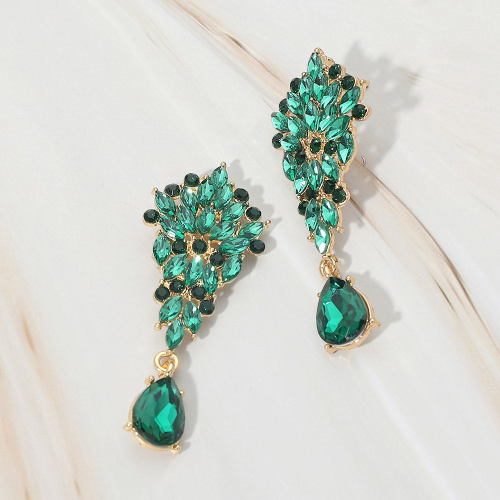 Emerald green floral marquise cluster teardrop drop earrings on gold on white marble background