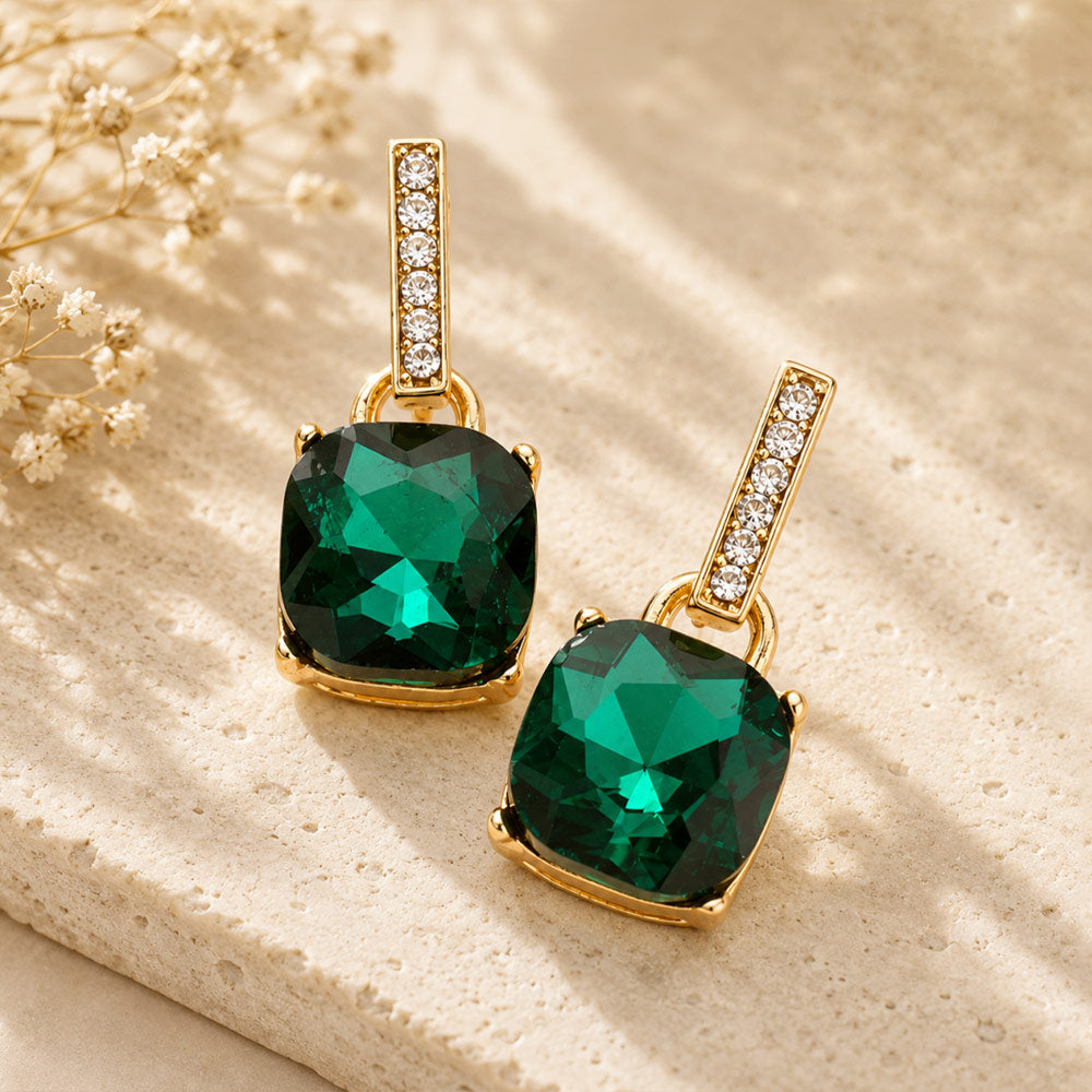 Emerald Green crystal cushion square dangle earrings on gold with a large cushion-cut stone suspended from a narrow crystal-lined bar, displayed on a white background.