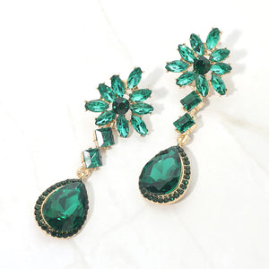 Emerald green crystal flower teardrop earrings in a gold finish featuring marquise crystal flower tops and large faceted emerald green teardrop drops, displayed on a white background.