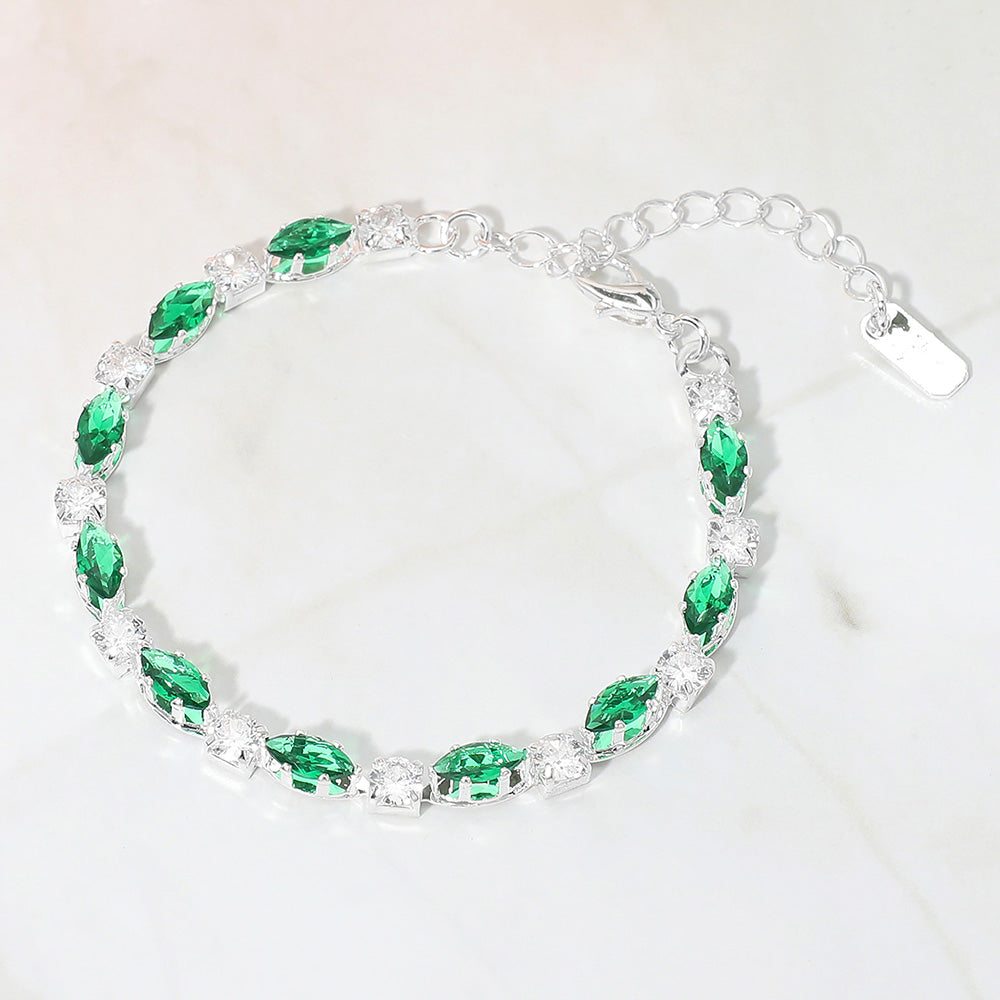Emerald Green marquise crystal prom bracelet on silver on white marble background