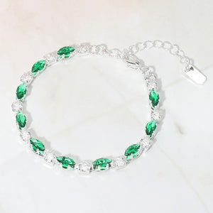 Emerald Green marquise crystal prom bracelet on silver on white marble background