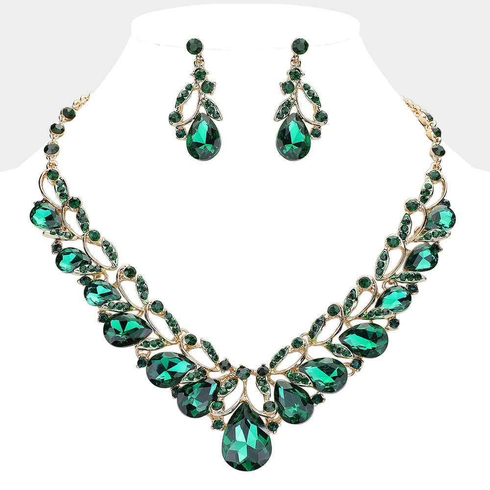 Emerald green teardrop leaf crystal statement necklace set with matching earrings in a gold setting on a white background