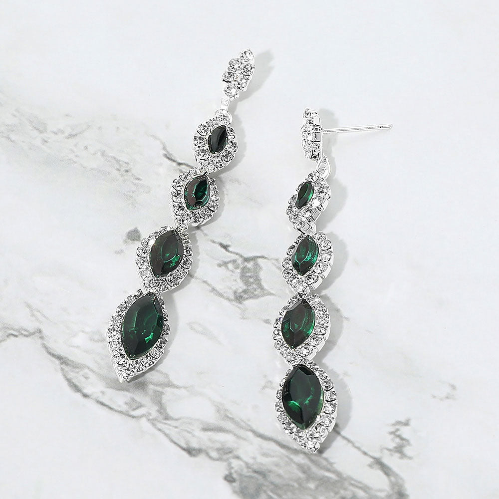 Emerald Green vintage marquise stone link drop formal evening earrings on silver with rhinestones on white marble background
