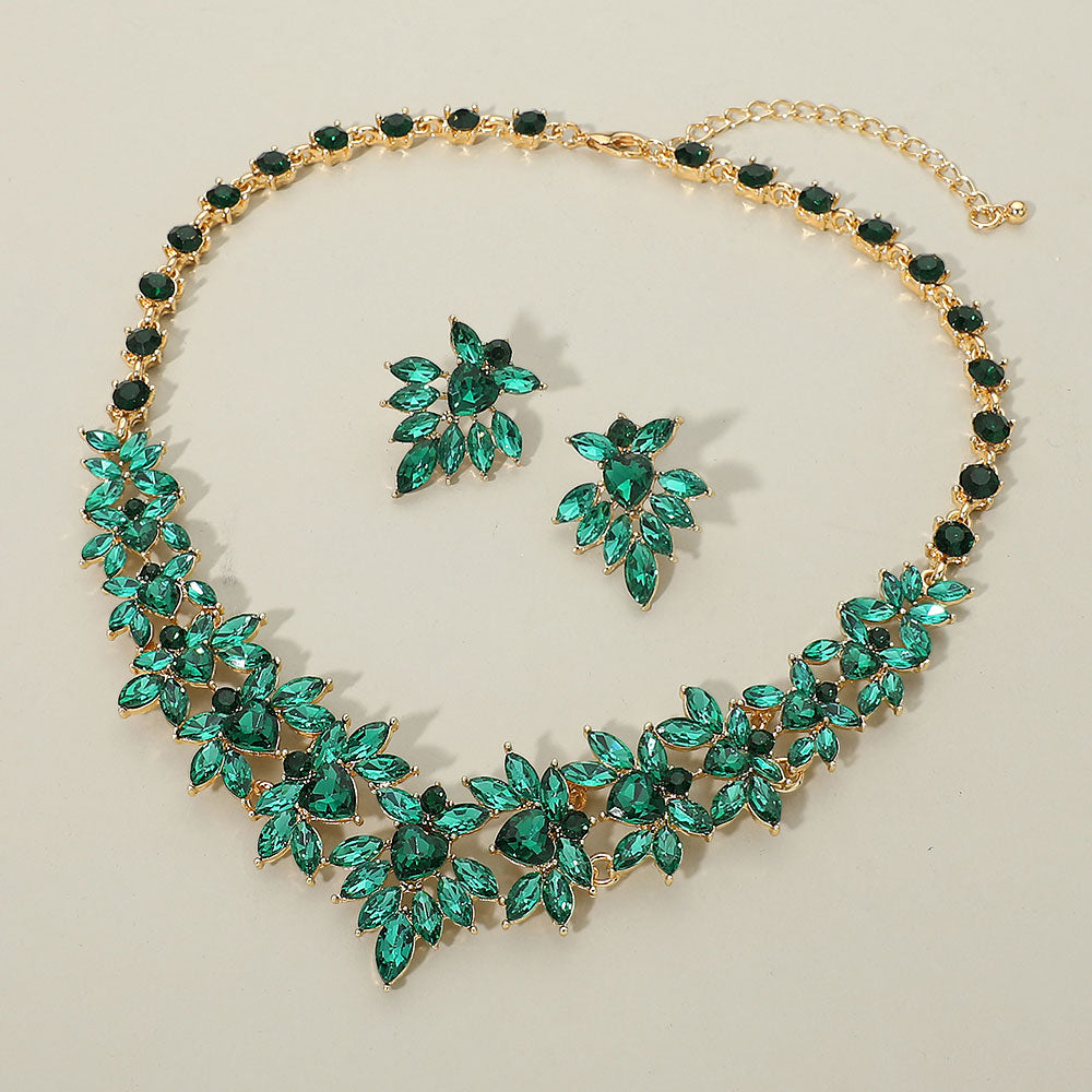 Emerald green marquise floral statement necklace set on gold on a beige background