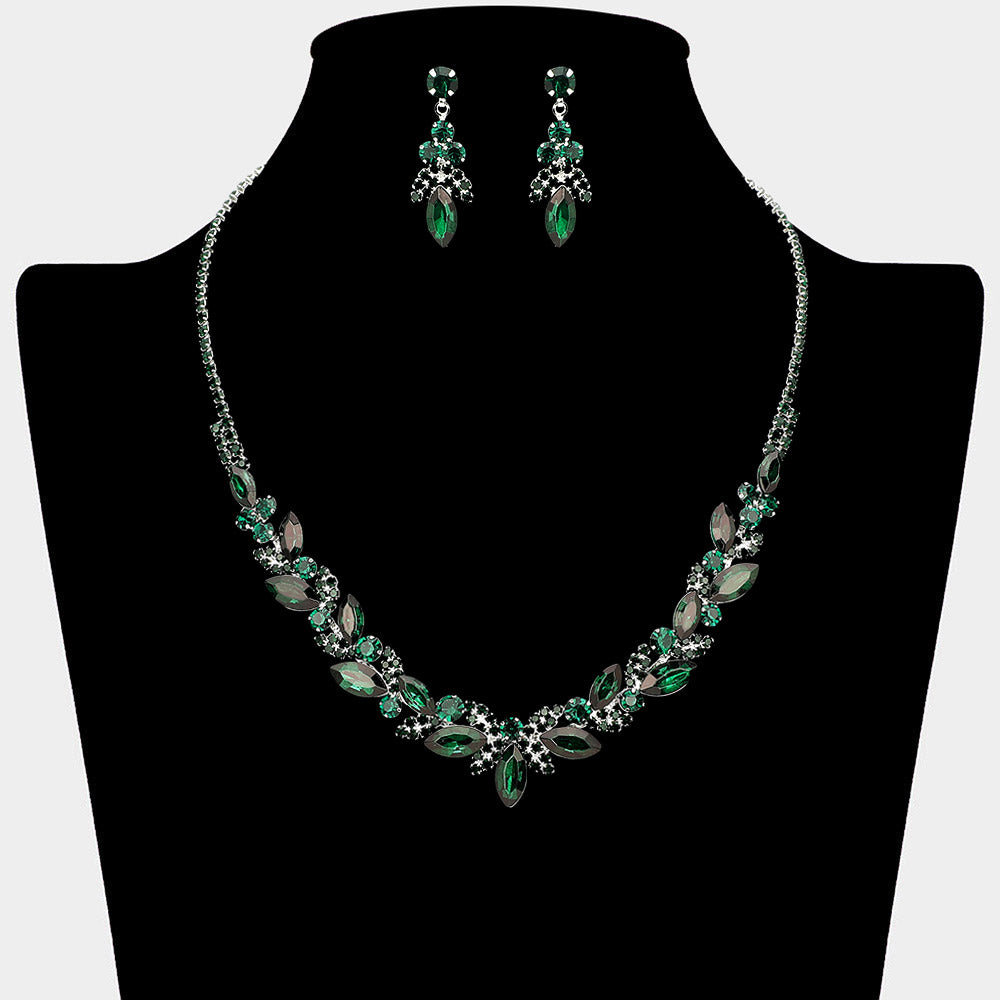 Emerald green marquise leaf rhinestone necklace set on silver displayed on black bust background