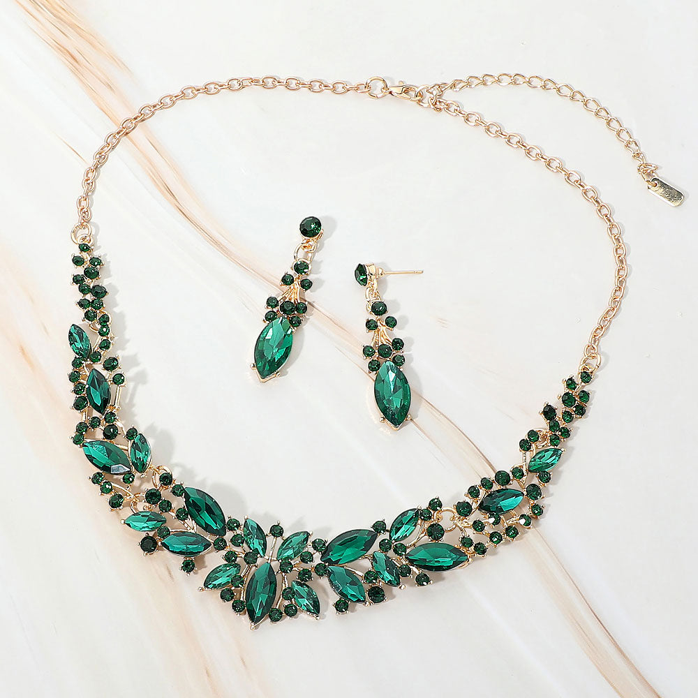 Emerald Green marquise stone cluster prom and evening necklace set on gold on white marble background