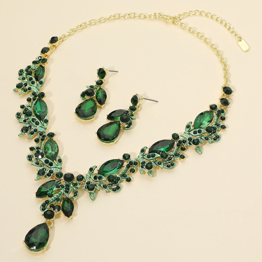Emerald Multi Stone Evening Necklace Set gold backed on a cream background