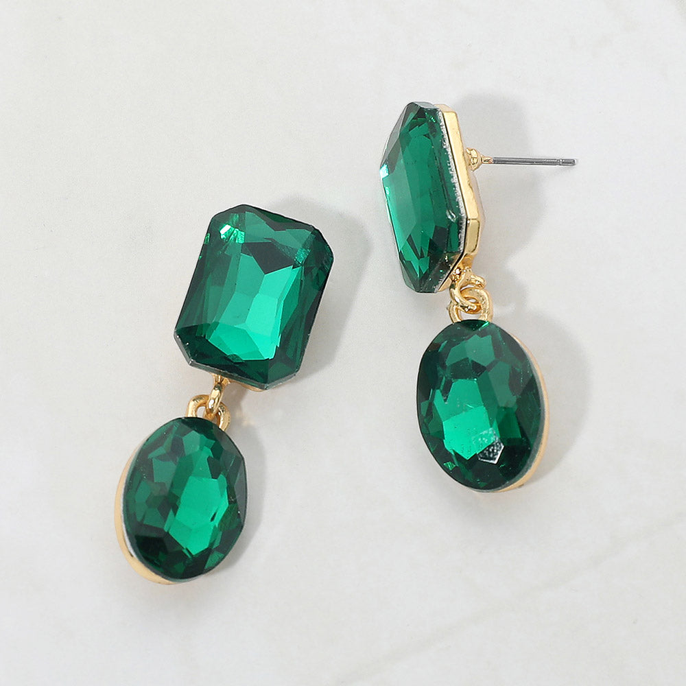 Emerald Green Oval and Emerald Cut Stone Dangle Pageant Earrings  | Interview Drop Earrings on Gold on a gray background