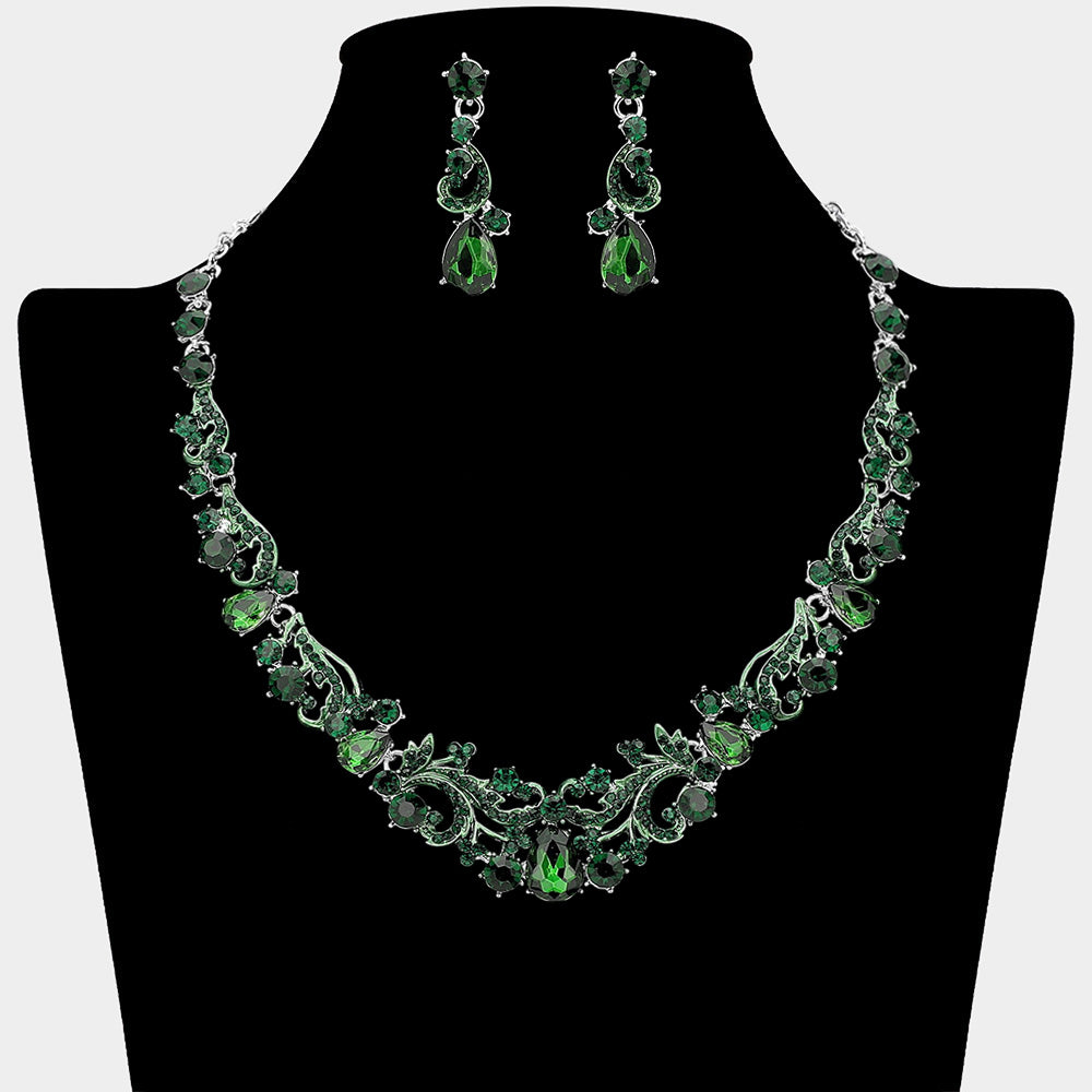 Emerald green teardrop rhinestone cluster necklace set on silver with matching earrings for prom and formal wear. Shown here on a black mannequin bust.
