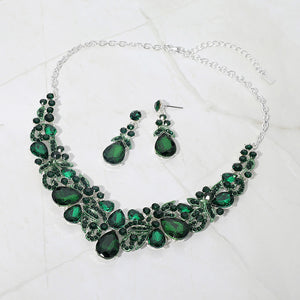 Emerald green teardrop floral statement necklace set on silver displayed on white background