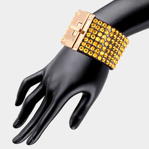 Gold on black 7-row rhinestone bling studded bracelet with gold hardware on a mannequin's wrist