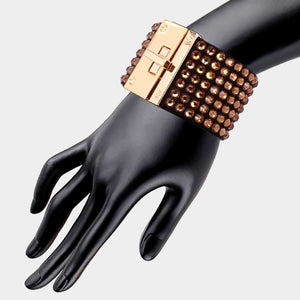 Light topaz gold stone on black 7-row rhinestone bling studded bracelet with gold hardware on a mannequin's wrist