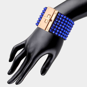 Sapphire (royal blue) on black 7-row rhinestone bling studded bracelet with gold hardware on a mannequin's wrist