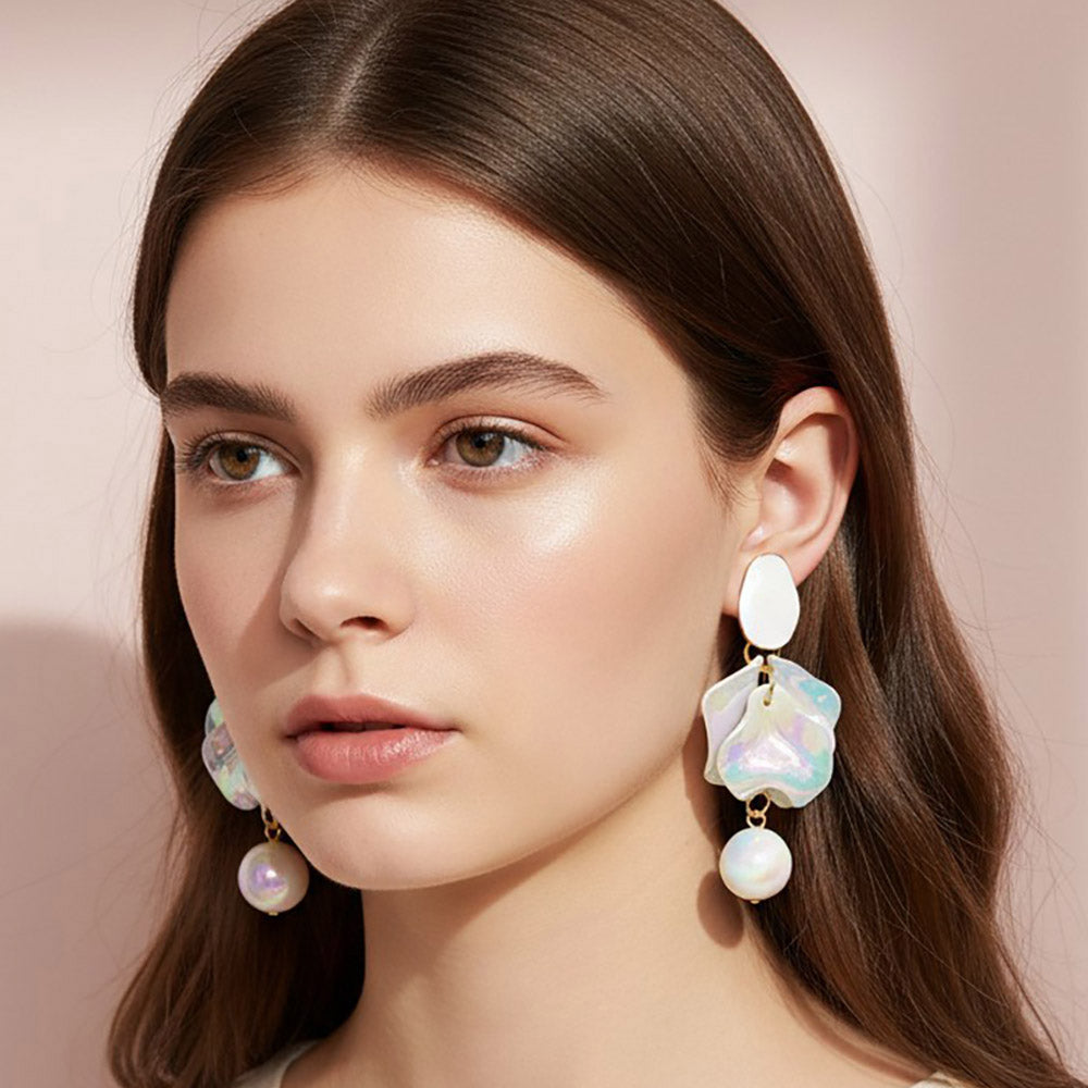 Woman wearing White iridescent layered petal statement dangle earrings on gold with reflective multicolor center accents and round white details.