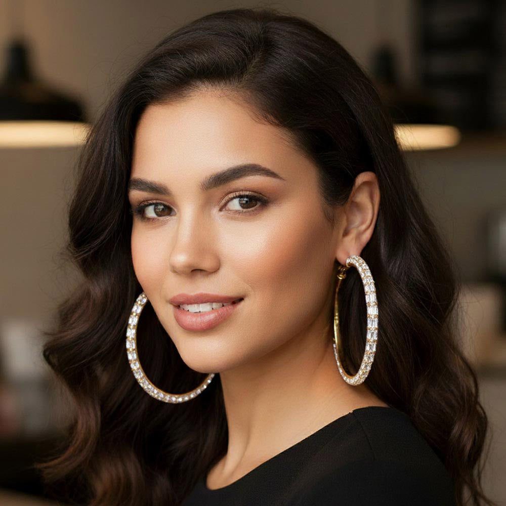 Oversized clear baguette rhinestone hoop earrings on gold 3.5 inch diameter worn by model