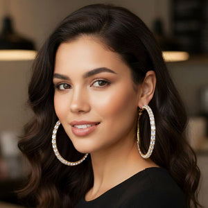 Oversized clear baguette rhinestone hoop earrings on gold 3.5 inch diameter worn by model