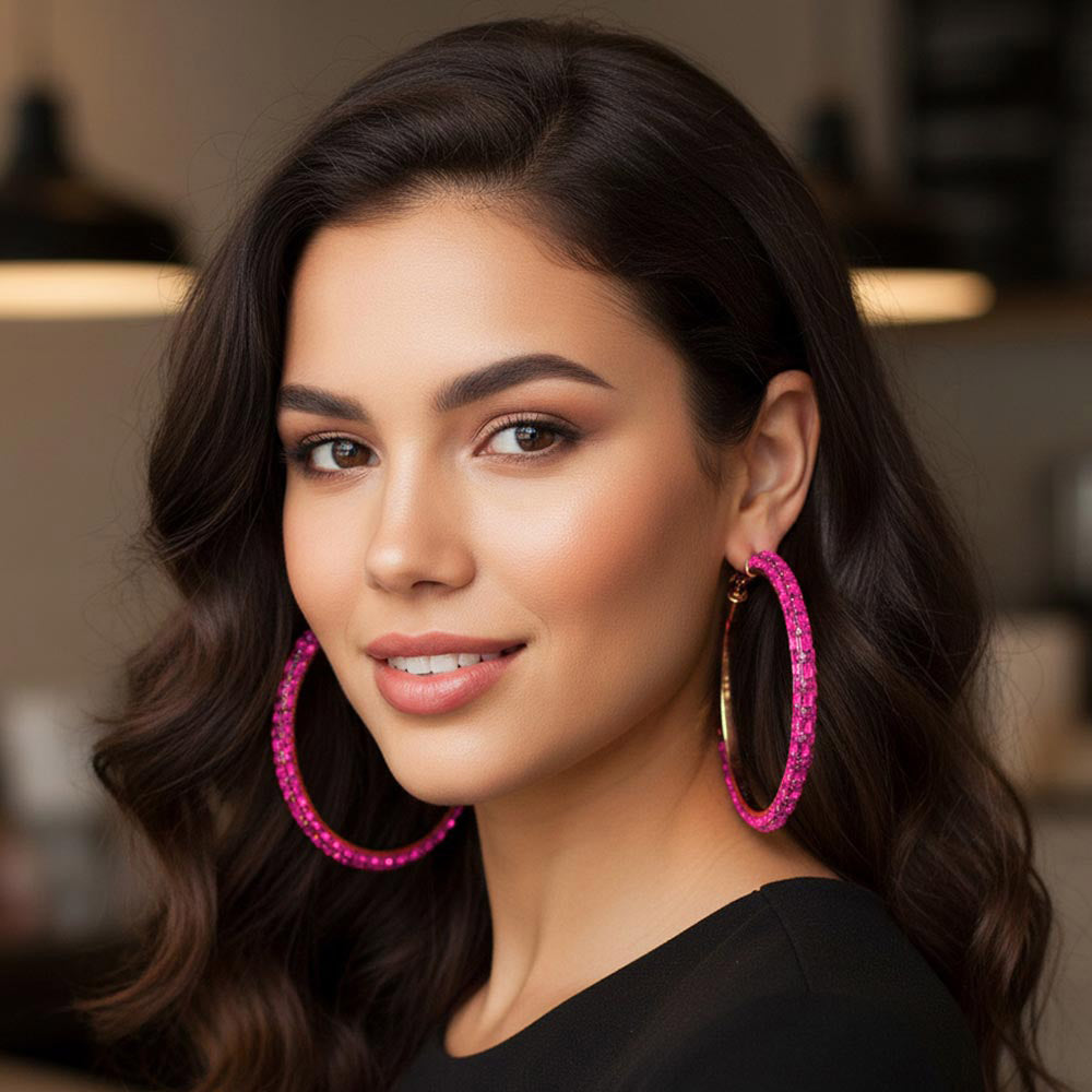 Oversized fuchsia hot pink baguette rhinestone hoop earrings on gold 3.5 inch diameter worn by model