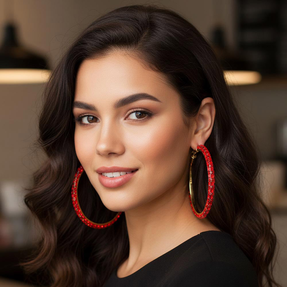 Red oversized baguette rhinestone hoop earrings on gold worn on model