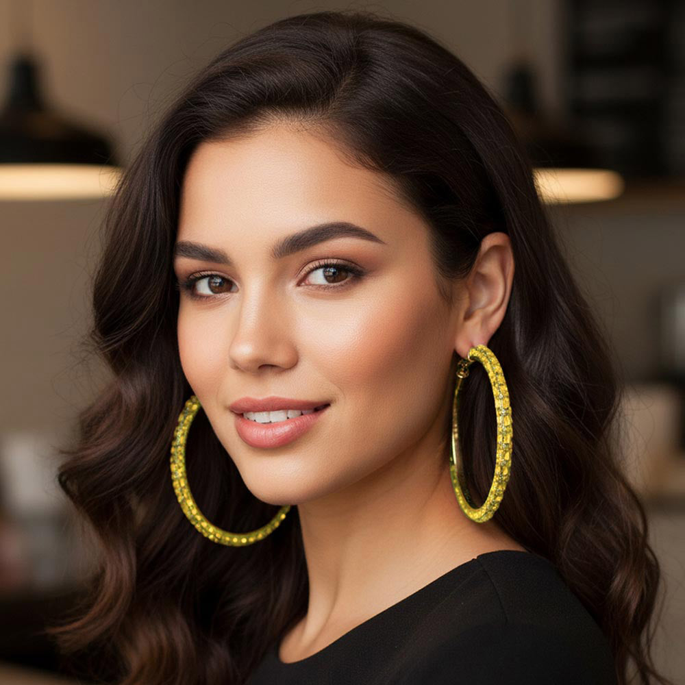 Oversized yellow baguette rhinestone hoop earrings on gold 3.5 inch diameter worn by model