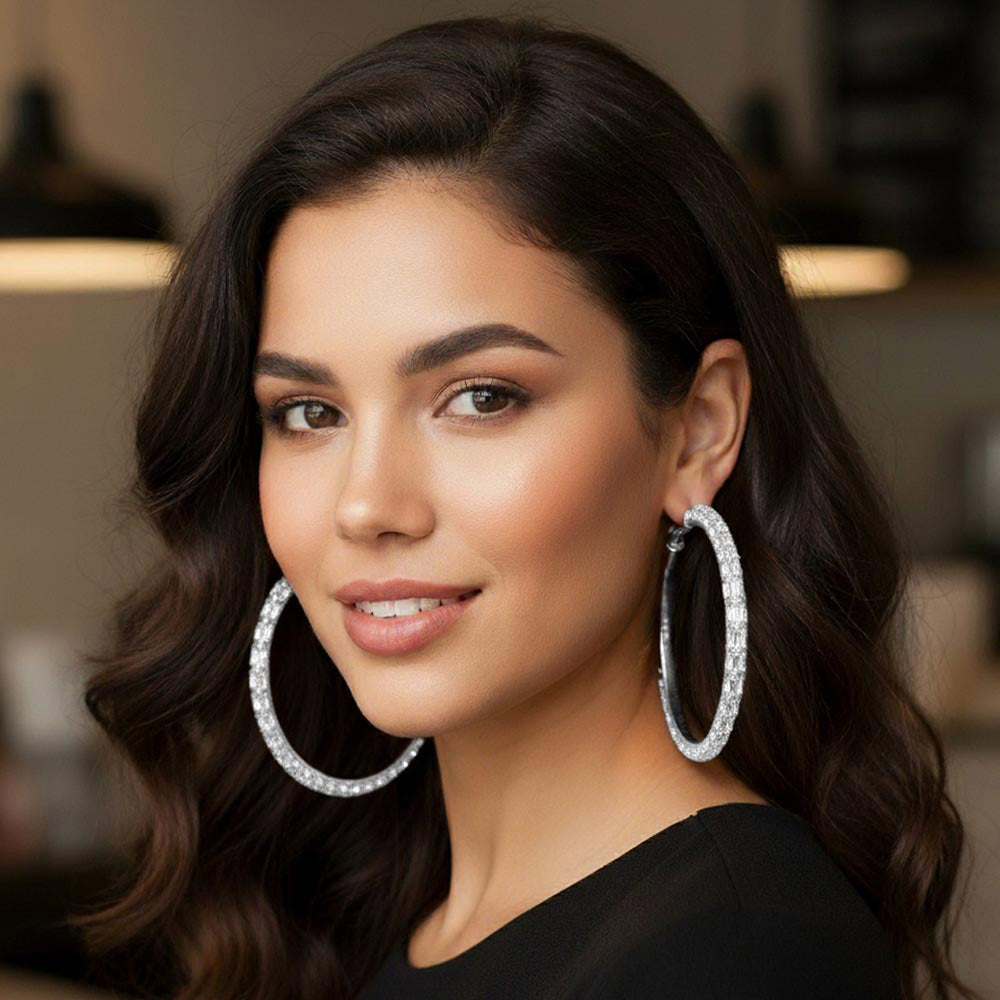 Clear oversized baguette rhinestone hoop earrings on silver worn on model
