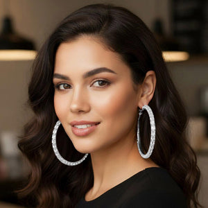Clear oversized baguette rhinestone hoop earrings on silver worn on model