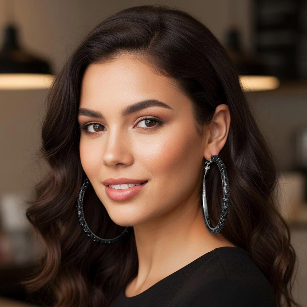 Jet black oversized baguette rhinestone hoop earrings on silver with omega back on a model