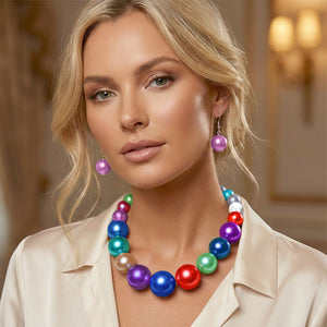 Multi color jewel tones Oversized Graduated Pearl Glossy Statement Necklace Set on silver shown on a woman on a blurry background.