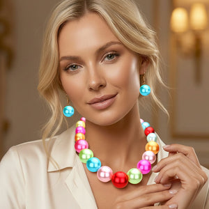 Multi colored pastels Oversized Graduated Pearl Glossy Statement Necklace Set on silver shown on a woman on a blurry background.