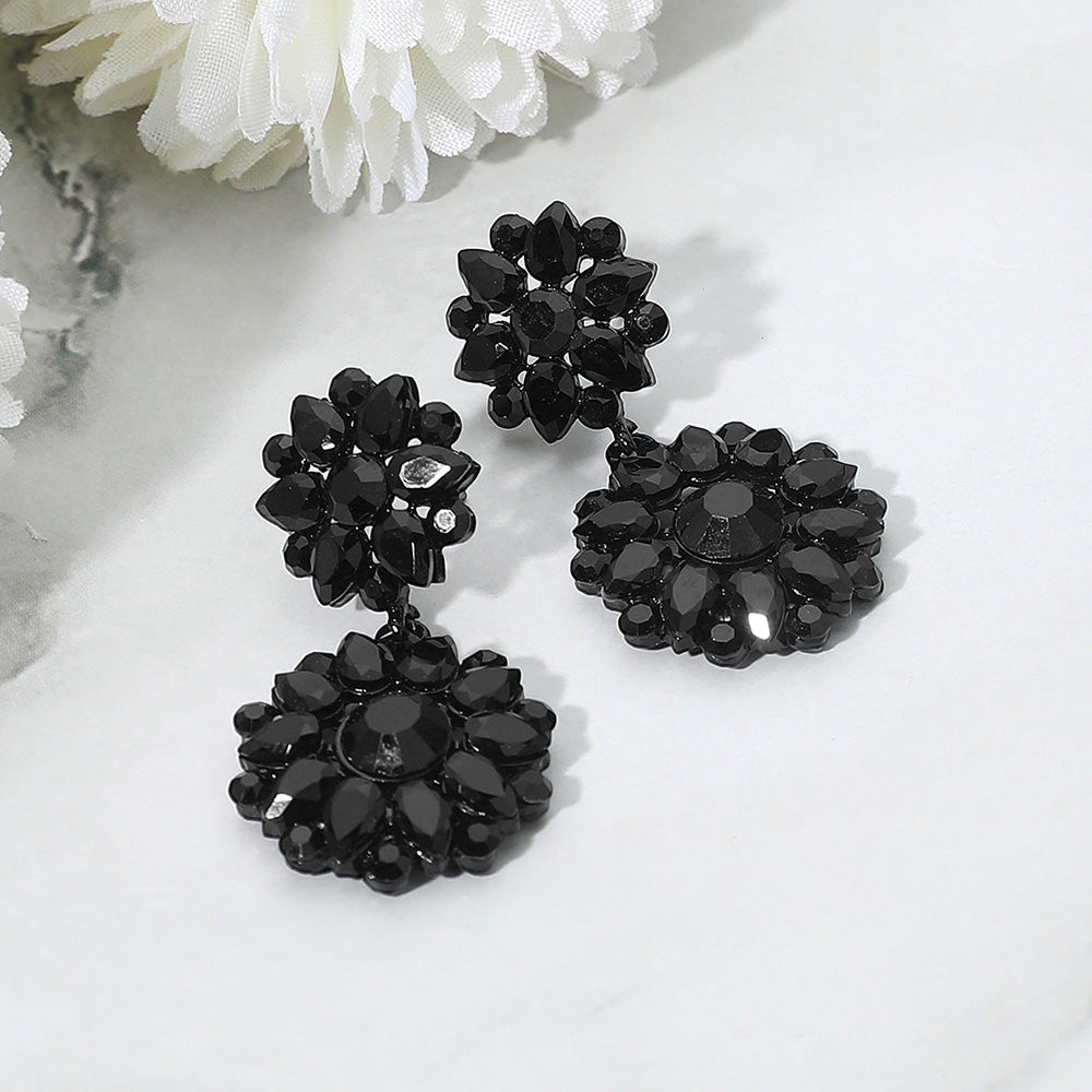 Jet black floral rhinestone cluster earrings for pageant, prom, or evening wear on a white background