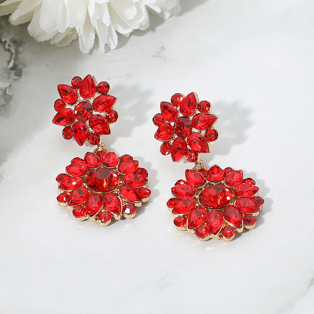 Red floral rhinestone cluster earrings with teardrop design for pageant or prom on a white background
