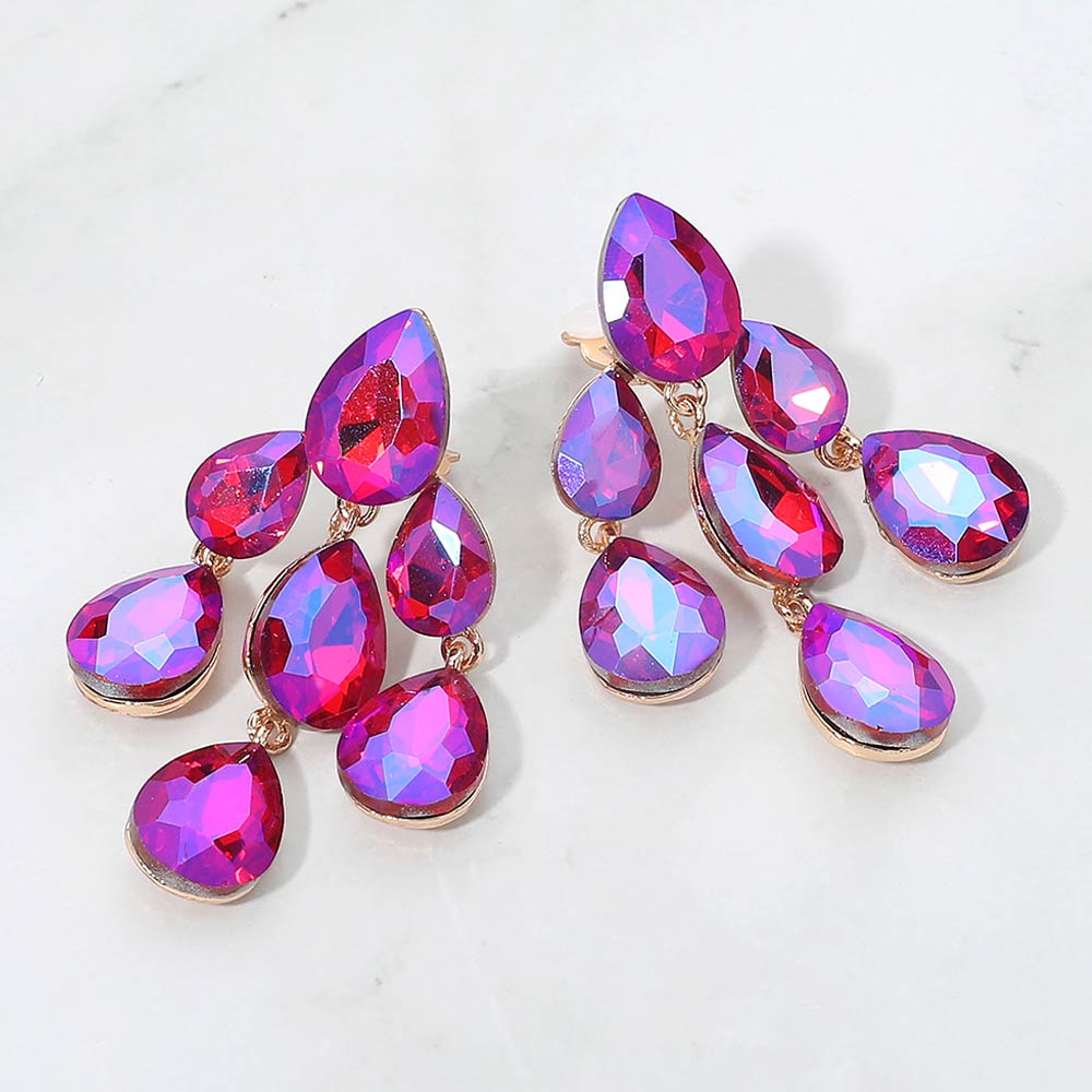 Fuchsia hot pink AB crystal teardrop cluster chandelier clip-on earrings on gold with iridescent stones on white marble background