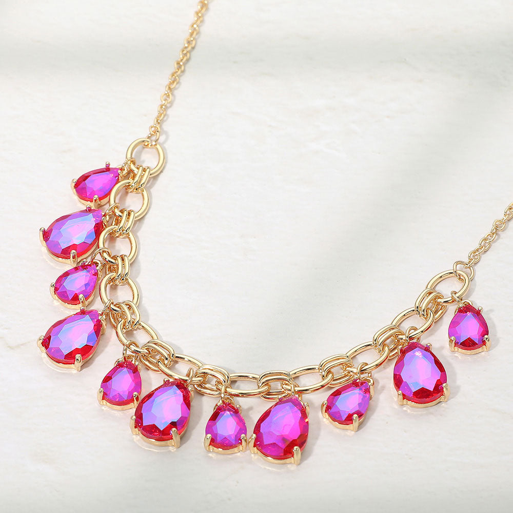 Fuchsia hot pink AB crystal teardrop statement necklace on gold on white background